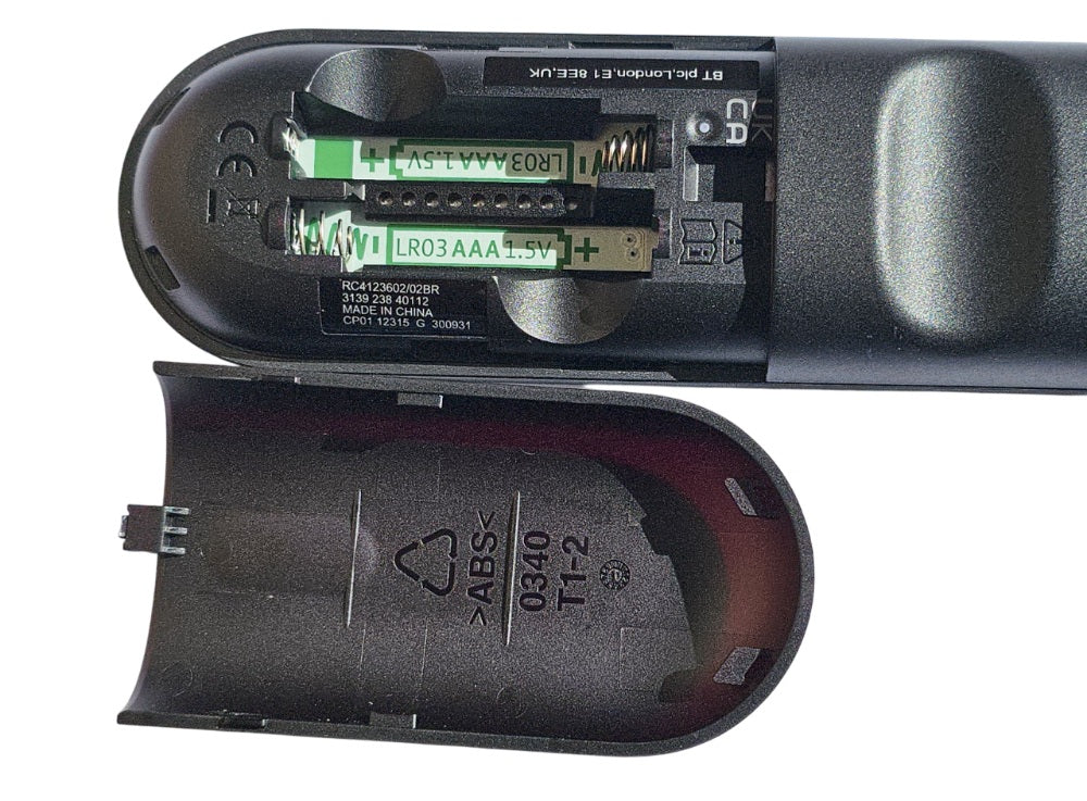 Close-up of a remote control battery compartment with batteries inside.