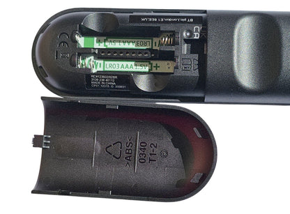 Close-up of a remote control battery compartment with batteries inside.